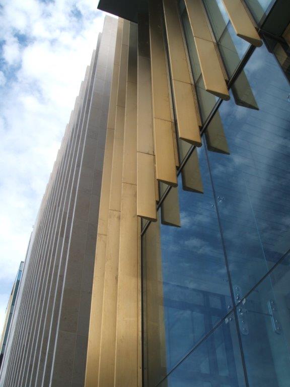 Close detail shot of the St Andrew Square's Nordic Royal copper alloy fins. From this perspective tapered form of the fins can be seen in detail. Next to the copper fins are similar one made from stone.