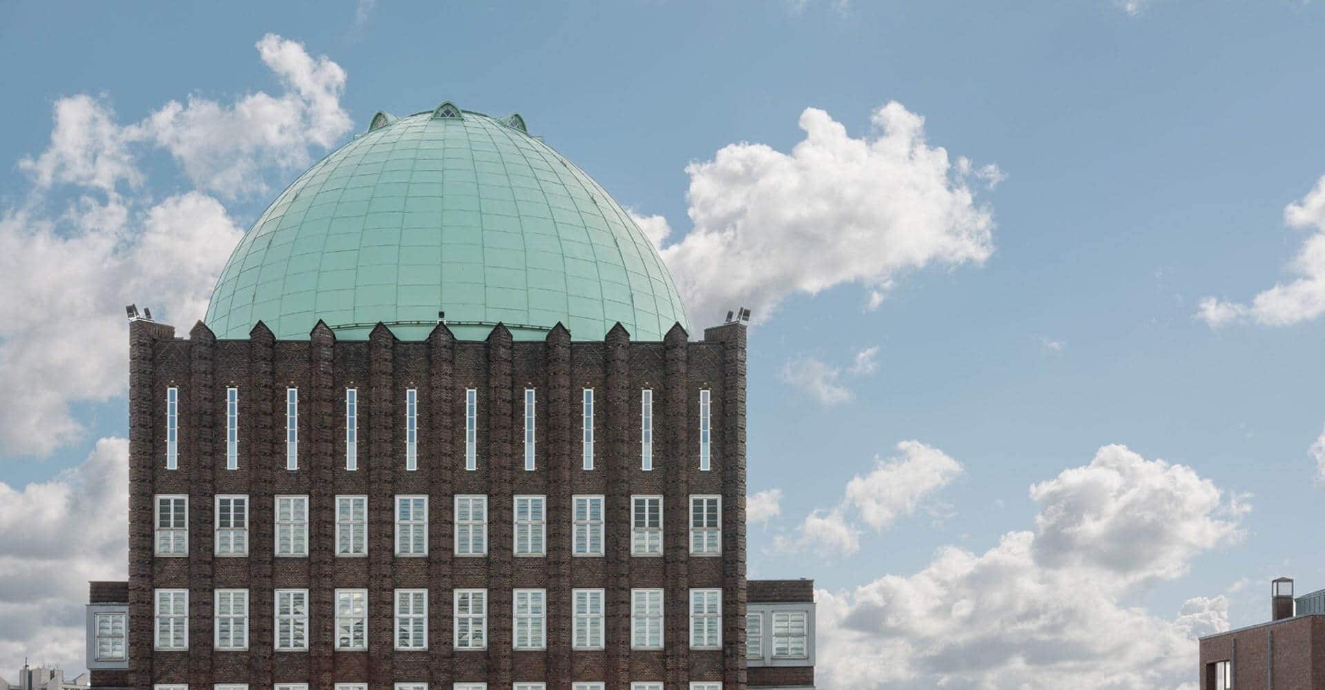 Building of completely renovated Anzeiger-Hochhaus Hannover located in Germany. The dome is equipped with Nordic Green copper by Nordic Copper from Aurubis Finland.