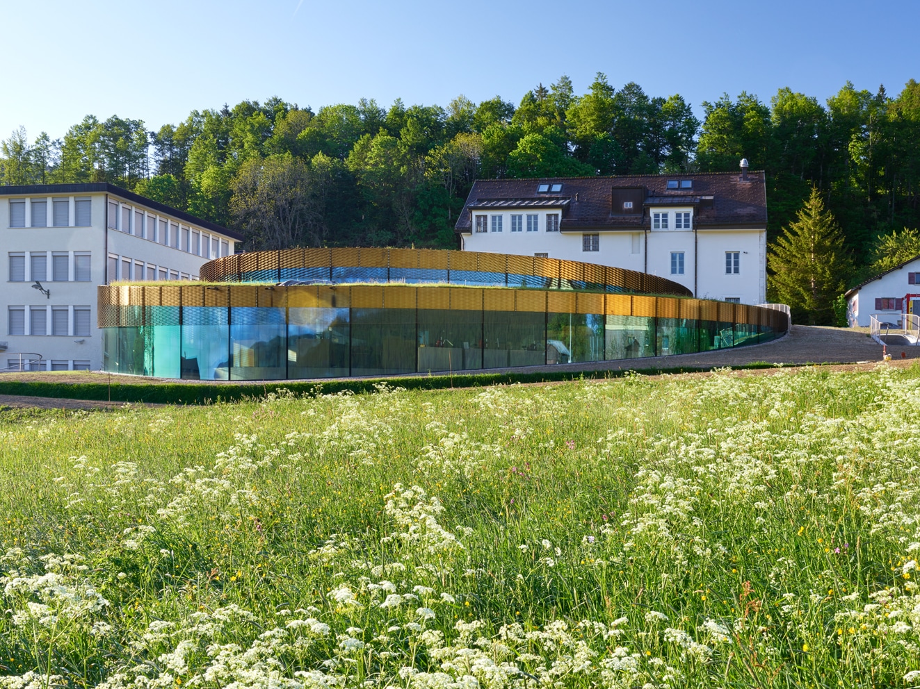 Side view of the Museum Maison des Fondateurs located in Switzerland. Building walls are clad from Nordic Brass copper.